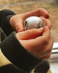 Zoomed in photo of a small Childs hand holding a small funko pop Jack Skellington